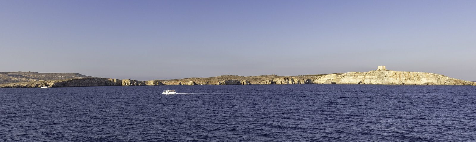 Comino island seen from the sea, with St Mary’s Tower